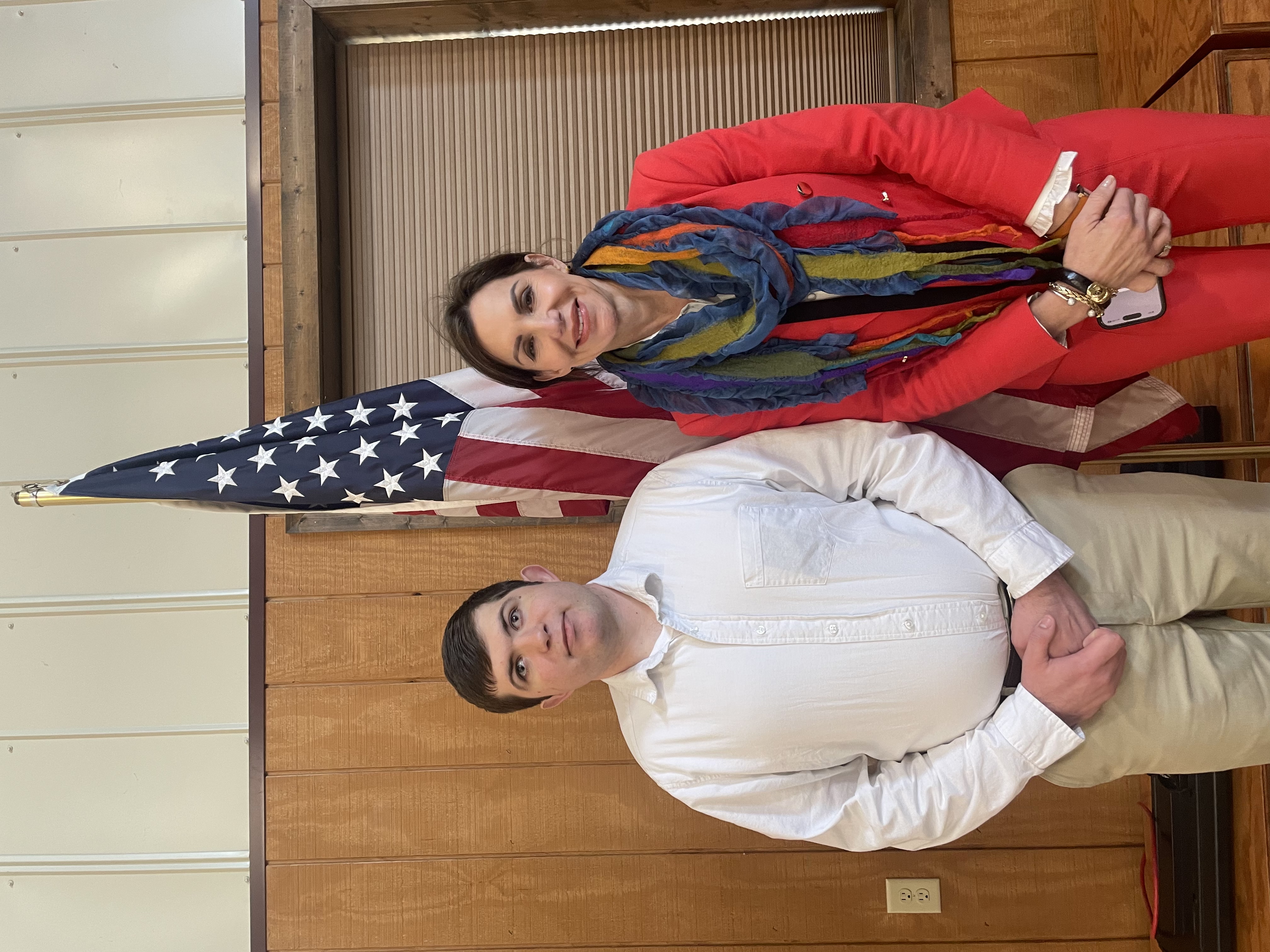Lucas Cook standing with an American flag